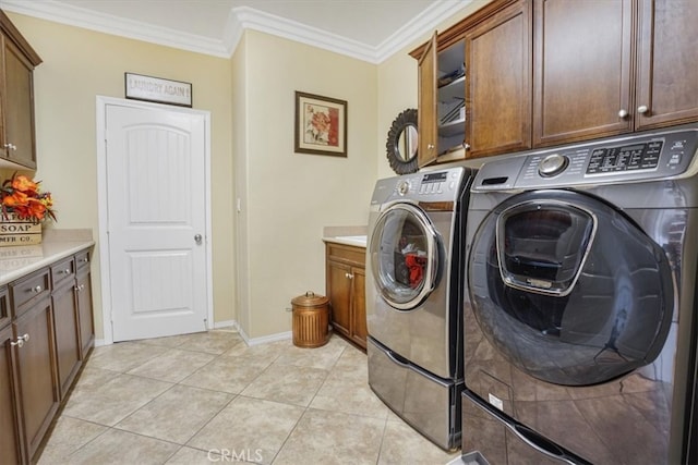 5003 Thornberry Way, Fontana, CA 92336 - laundry area with light tile patterned flooring, washing machine and clothes dryer, crown molding, and cabinet space