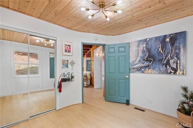 bedroom with wood ceiling, a closet, and hardwood / wood-style flooring