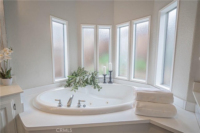 bathroom featuring vanity and a washtub