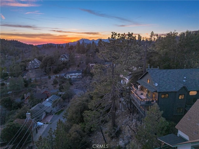 aerial view at dusk featuring a mountain view