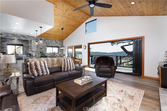 living room with light wood finished floors, baseboards, wooden ceiling, and ceiling fan