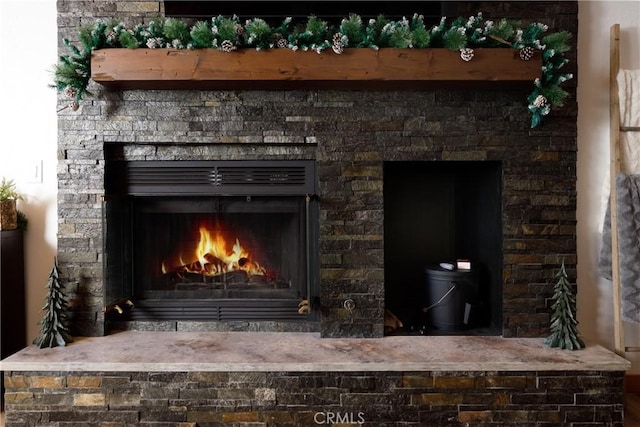 interior details featuring a warm lit fireplace