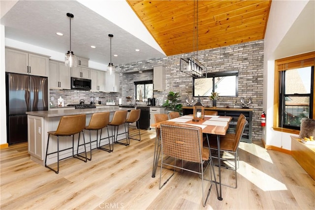 dining area featuring light wood-style floors, lofted ceiling, and recessed lighting