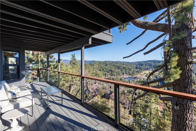 wooden deck with a forest view