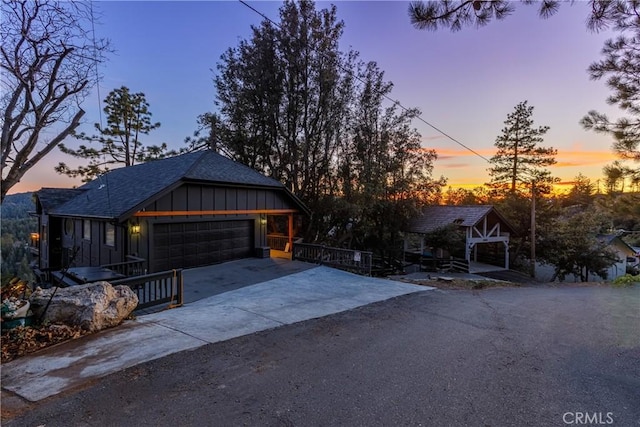 view of front of property featuring concrete driveway, a gazebo, board and batten siding, and an attached garage