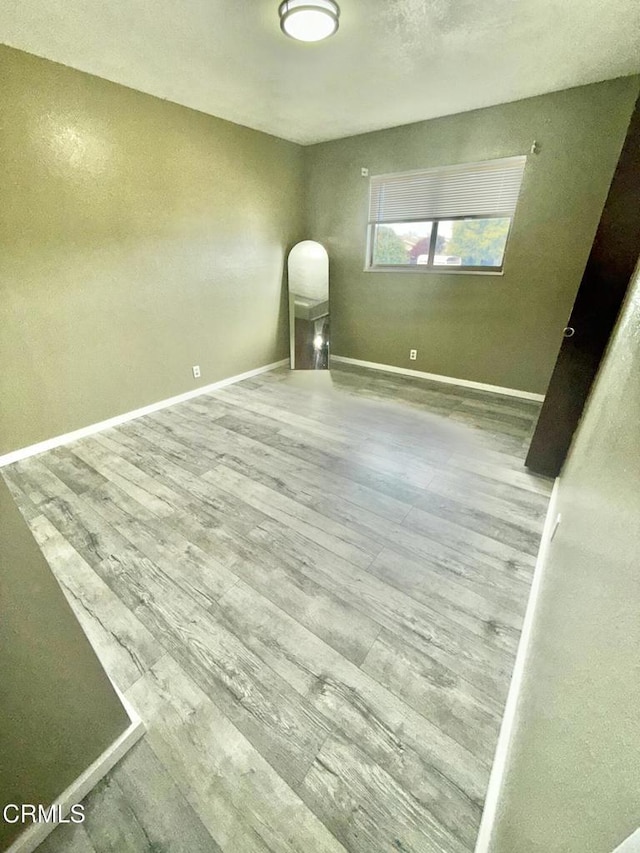 unfurnished room featuring wood-type flooring