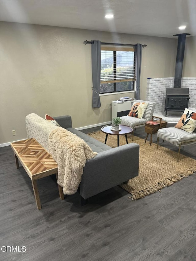 living room featuring a wood stove and dark hardwood / wood-style flooring