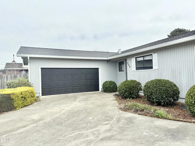 single story home with concrete driveway and an attached garage