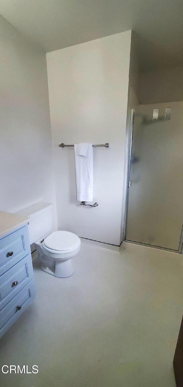 full bathroom with a shower stall and toilet