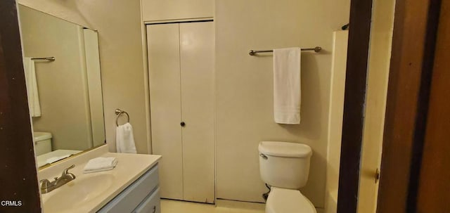 bathroom with toilet and vanity