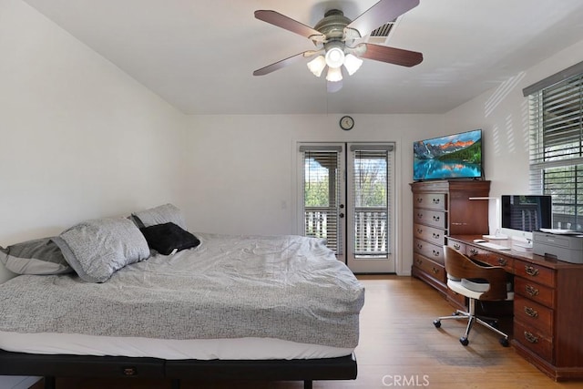 bedroom featuring access to outside, light wood-style flooring, and a ceiling fan