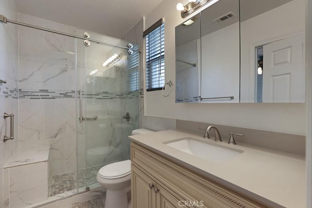 bathroom with a marble finish shower, visible vents, toilet, marble finish floor, and vanity