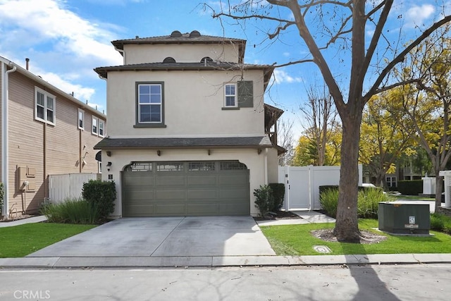 view of front of house with fence, driveway, an attached garage, and stucco siding