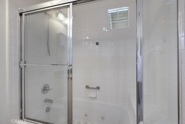 bathroom with a combined bath / shower with jetted tub