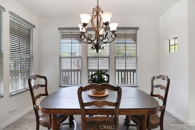 dining space with baseboards, light wood-style floors, and a healthy amount of sunlight