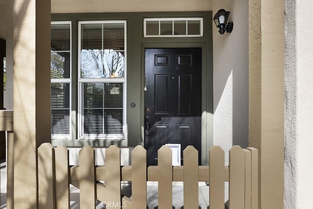 entrance to property with stucco siding