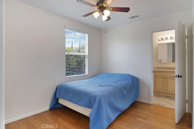 bedroom with baseboards, visible vents, and light wood-style floors