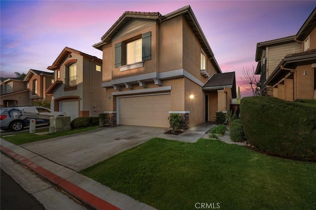 view of property with a garage and a lawn