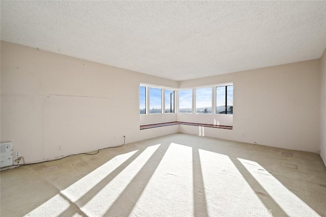 unfurnished room featuring a textured ceiling