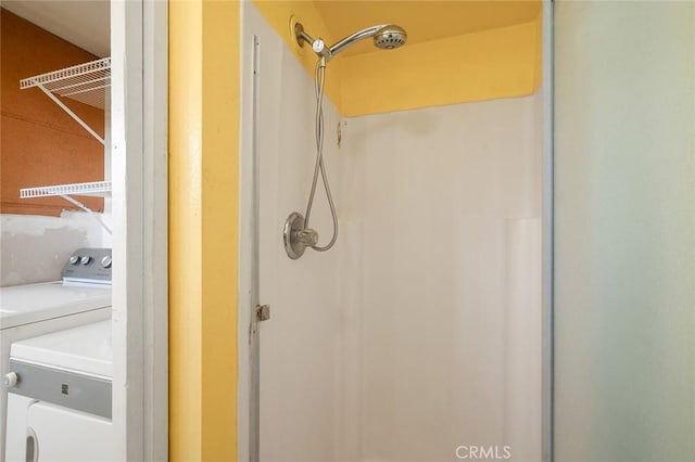 bathroom featuring washing machine and clothes dryer and walk in shower