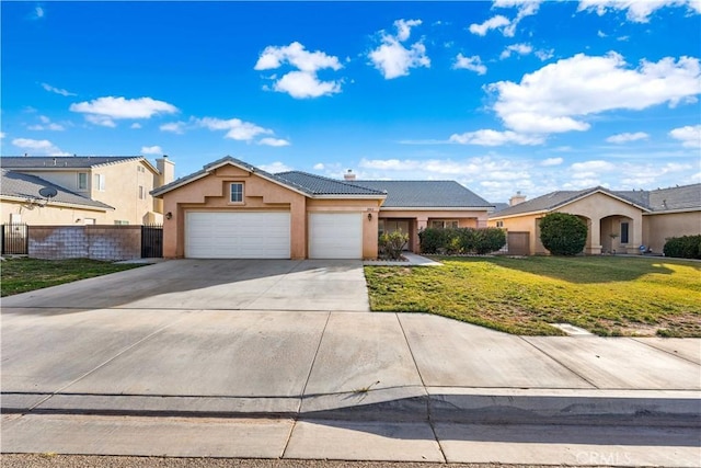 single story home featuring a garage and a front lawn