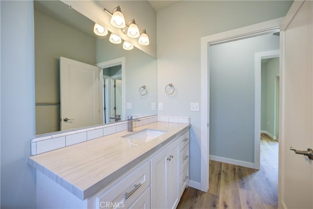 bathroom with vanity and wood-type flooring