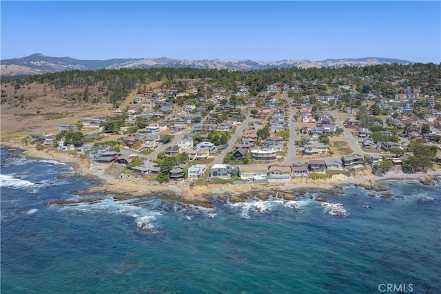 birds eye view of property with a water and mountain view