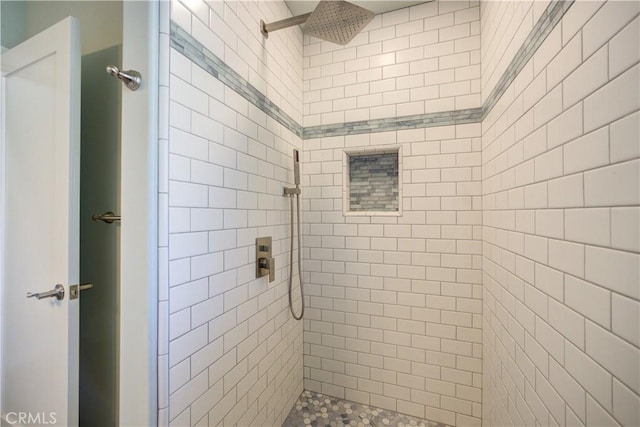 bathroom with tiled shower