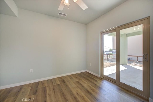 spare room with hardwood / wood-style floors and ceiling fan