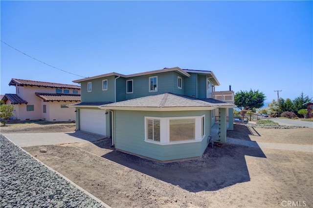 front of property featuring a garage and a balcony