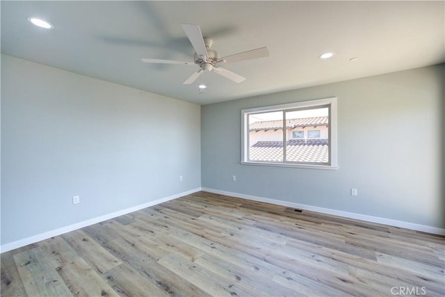 spare room featuring ceiling fan and light hardwood / wood-style floors