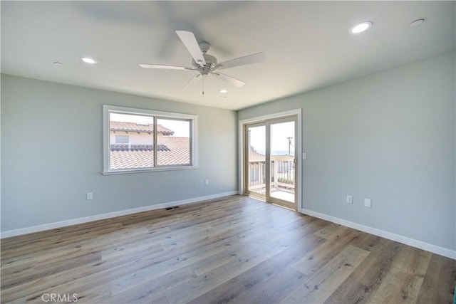 empty room featuring ceiling fan and light hardwood / wood-style flooring