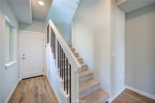 staircase featuring wood-type flooring