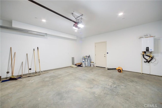 garage with a garage door opener and tankless water heater