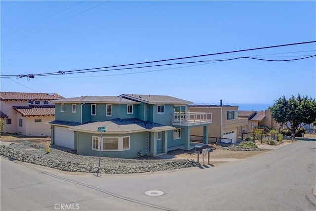 view of front of house with a garage and a balcony