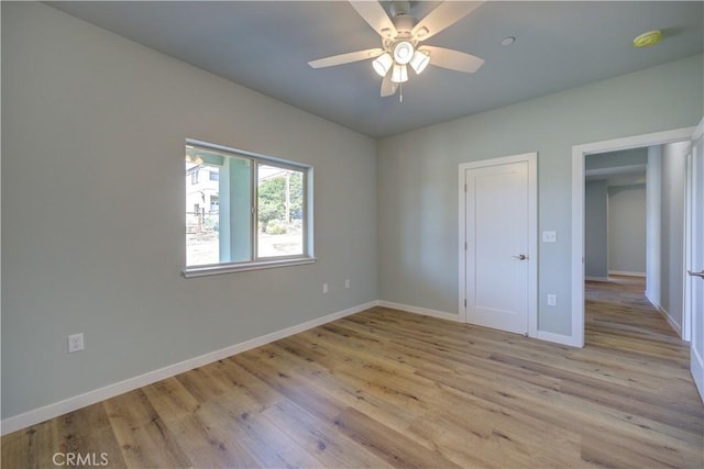 unfurnished room featuring ceiling fan and light wood-type flooring
