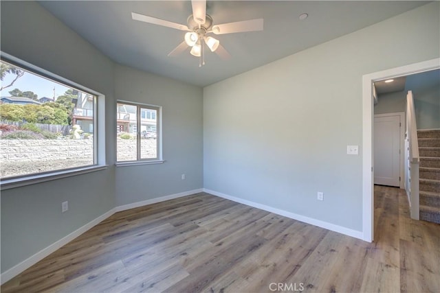empty room featuring light hardwood / wood-style flooring and ceiling fan