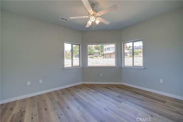 spare room featuring ceiling fan and light wood-type flooring