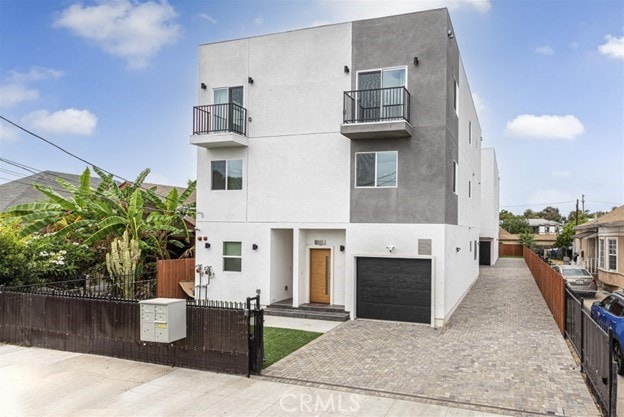 view of front of house with a balcony and a garage