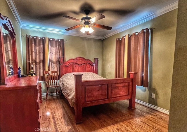 bedroom with baseboards, wood finished floors, a ceiling fan, and crown molding