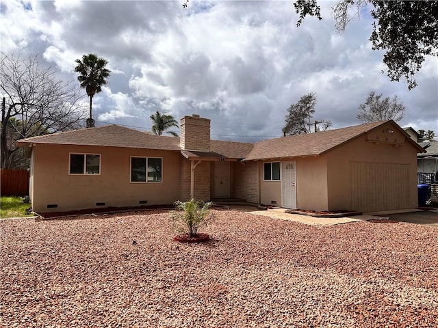 rear view of house with a shingled roof, fence, stucco siding, a chimney, and crawl space