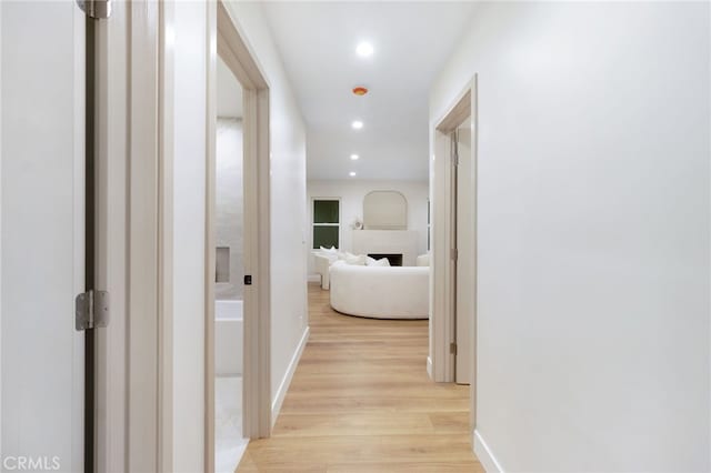 corridor with light hardwood / wood-style flooring