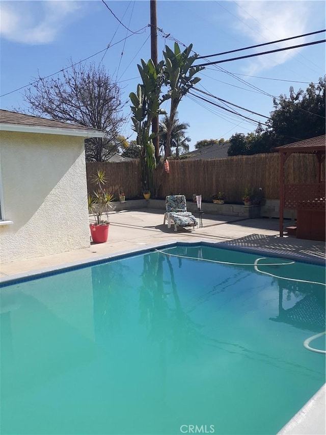 view of swimming pool featuring a fenced in pool, a patio area, and a fenced backyard