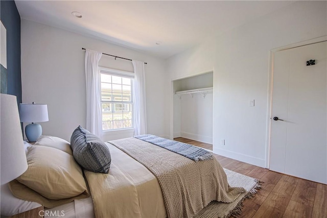 bedroom featuring a closet and light wood-type flooring