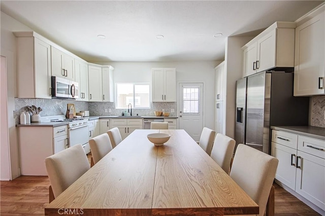 kitchen featuring white cabinetry, sink, a center island, and appliances with stainless steel finishes