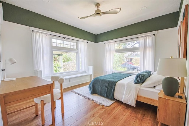 bedroom with hardwood / wood-style flooring and ceiling fan