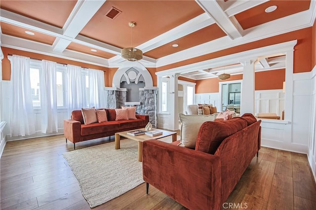 living room with beamed ceiling, wood-type flooring, coffered ceiling, and decorative columns