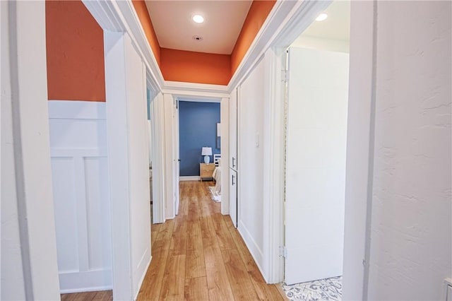 hallway with light hardwood / wood-style floors