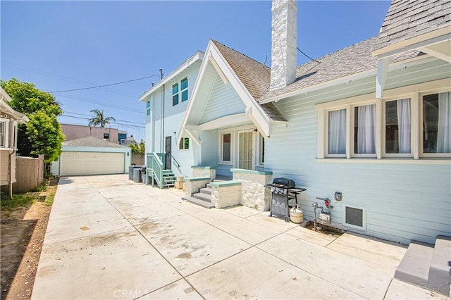 back of property with a garage and an outdoor structure