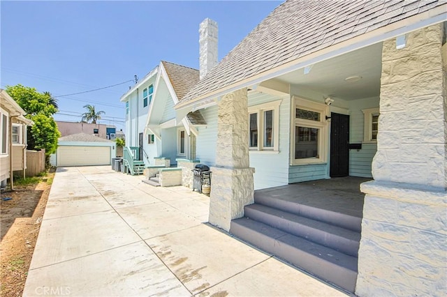 exterior space featuring a garage and an outdoor structure